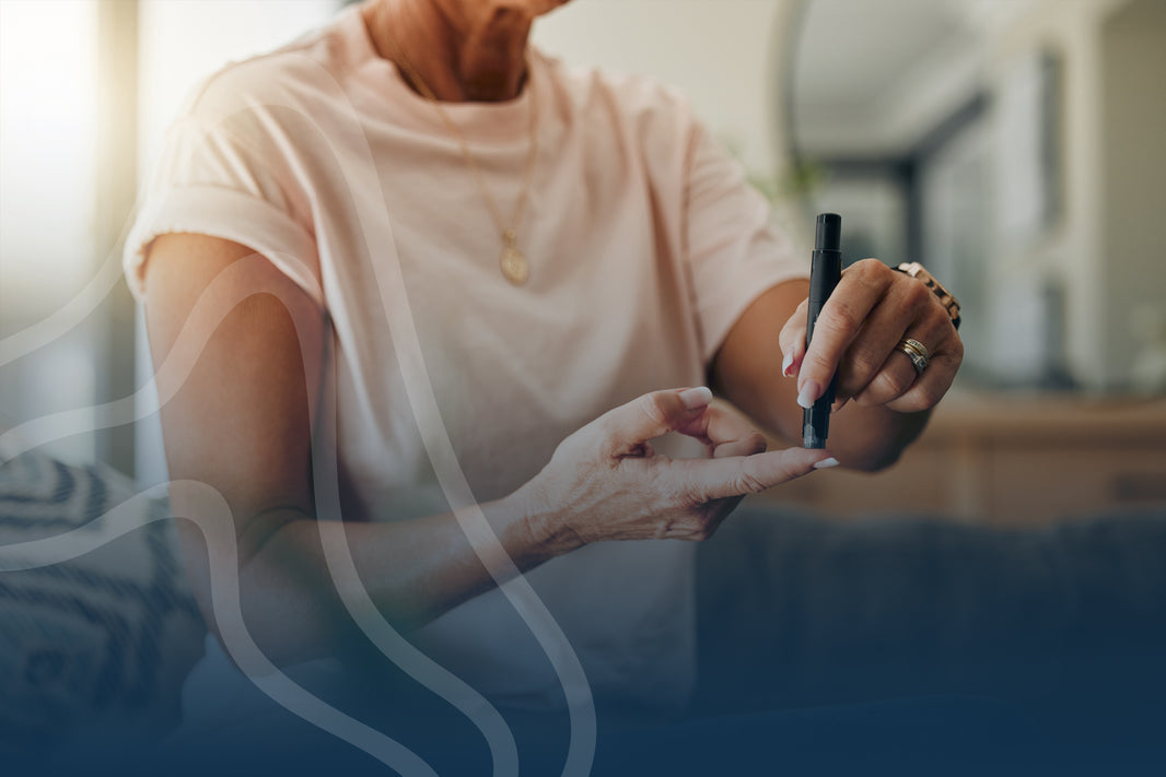 Person using a pen to check blood sugar levels on their fingertip.